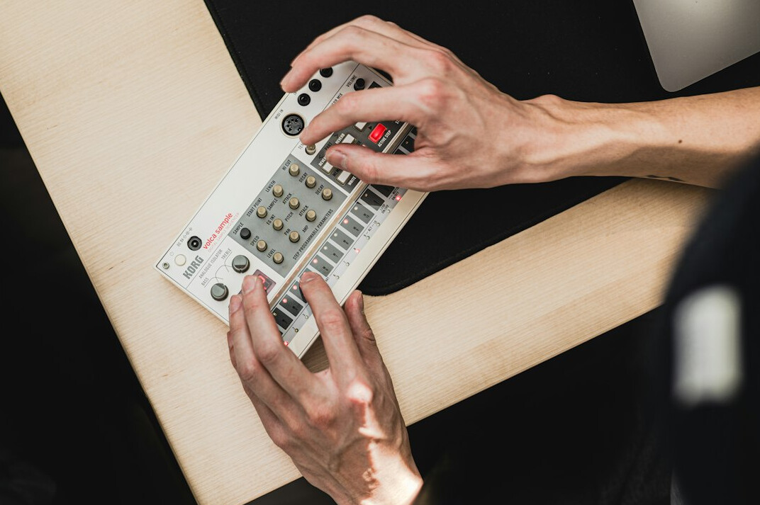 Hands on an editing control panel with a timeline on screen