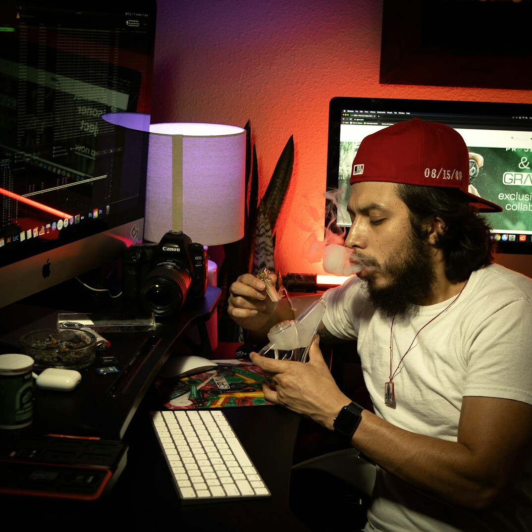 Video editor working at a dual-monitor editing station